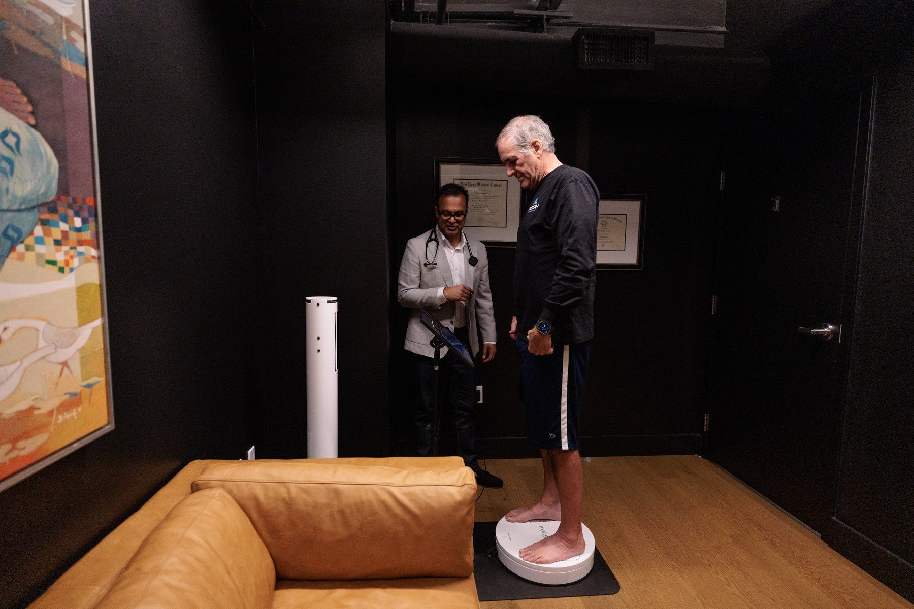 A member stepping onto the Styku 3D body imaging platform for a body composition scan at Aeon Wellness Club