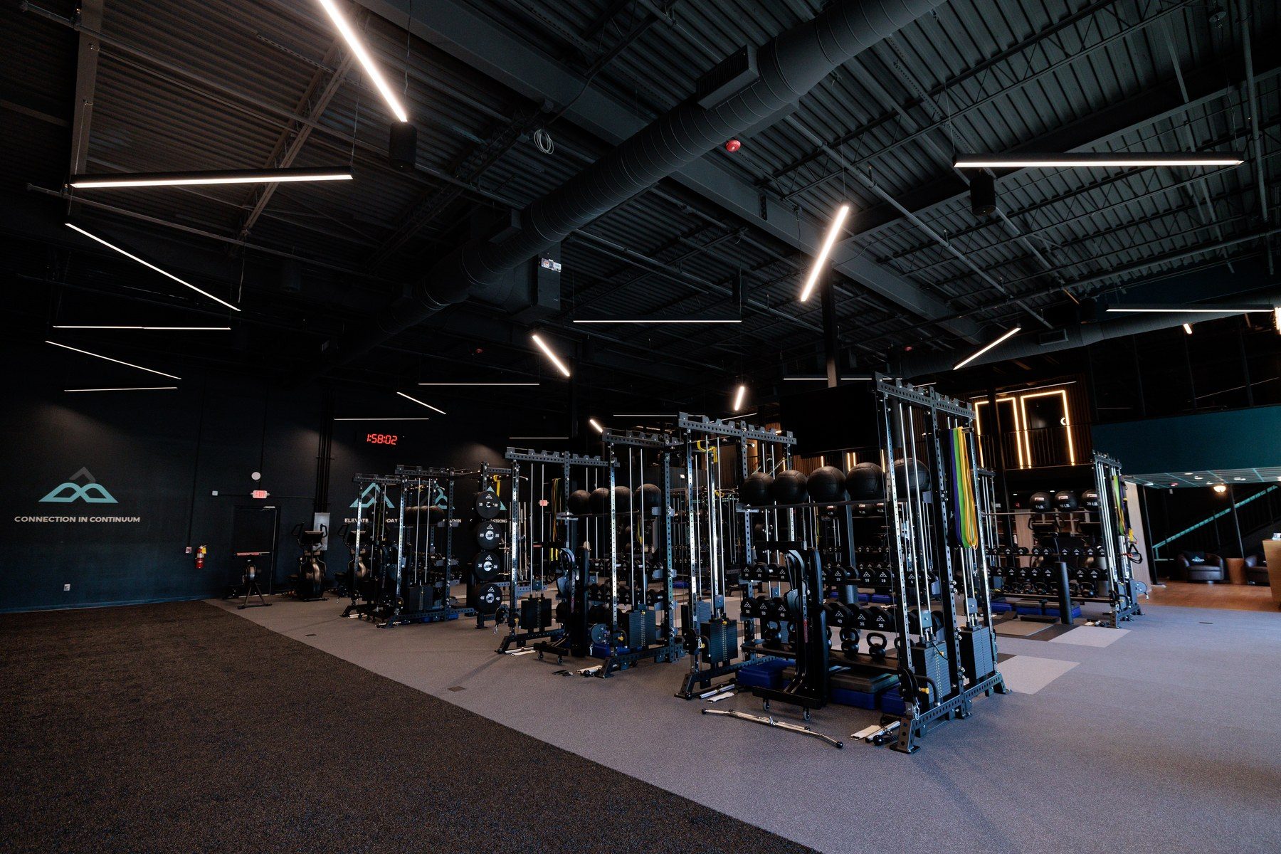 The main training floor at Aeon Wellness Club in Alpharetta, lined with individually equipped private training pods
