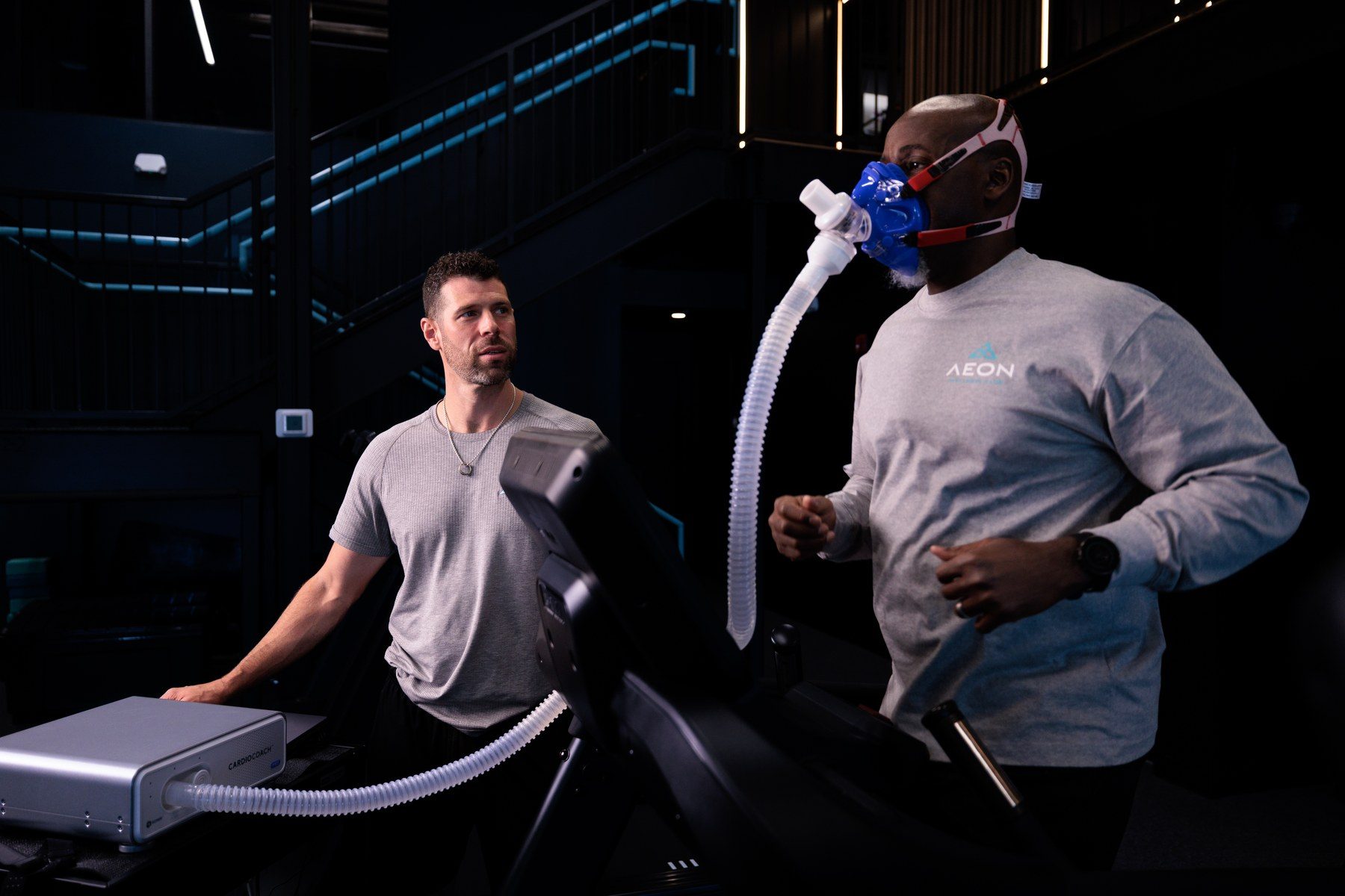 A member wearing a metabolic testing mask during a VO2 assessment on the KORR CardioCoach at Aeon Wellness Club