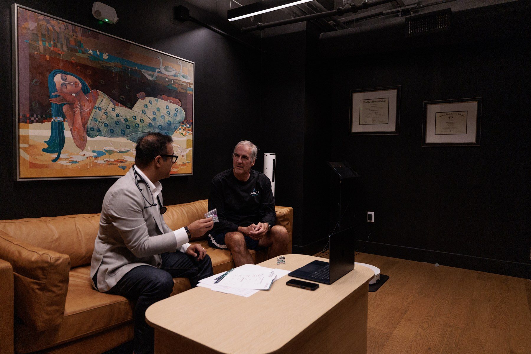 A clinician reviewing lab results with a member ahead of a peptide therapy consultation